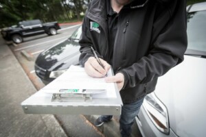 a photo of a 1UP Floors Sales/Service Ninja writing measurements down