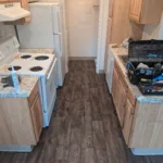 Two layers of loose vinyl had to be removed. Cracks and rough spots in the subfloor needed repair. Timing was critical to avoid delays in the unit turn.